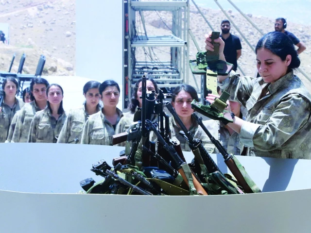 fighters with the kurdistan workers party line up to put their weapons into a pit during a ceremony in sulaimaniyah in iraq s autonomous kurdistan region photo afp fighters with the kurdistan workers party line up to put their weapons into a pit during a ceremony in sulaimaniyah in iraq s autonomous kurdistan region photo afp