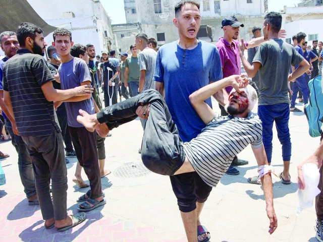 a man carries a palestinian injured in an israeli strike outside a hospital in gaza photo afp a man carries a palestinian injured in an israeli strike outside a hospital in gaza photo afp