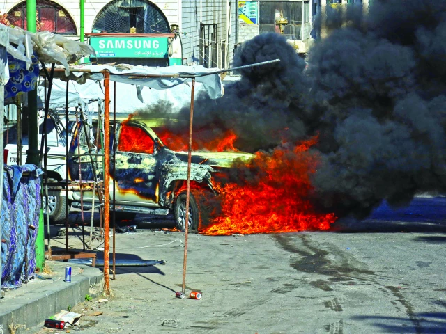 a vehicle burns in a street after syrian government forces pulled out of the southern sweida governorate photo afp