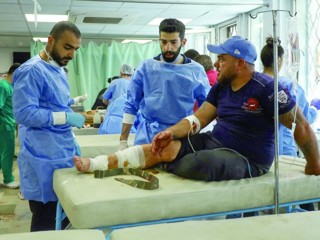 a wounded man receives treatment at a hospital in syria s southern city of sweida photo afp