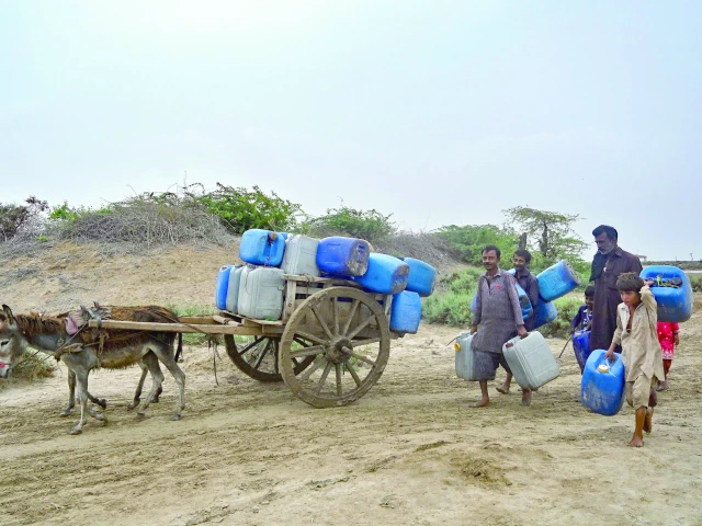local residents carrying water cans head toward boats delivering drinking water to an island village in kharo chan town located in the indus delta photo afp local residents carrying water cans head toward boats delivering drinking water to an island village in kharo chan town located in the indus delta photo afp
