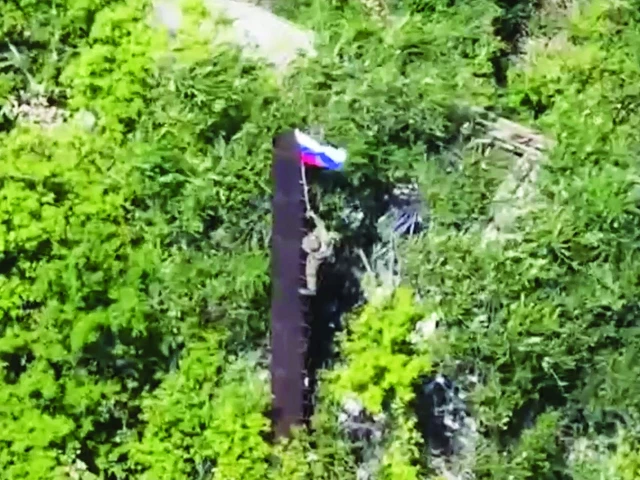 a still image taken from footage released by the russian defence ministry shows what it said to be a russian soldier raising a flag following the capture of ukraine s yablunivka settlement in the donetsk region photo reuters a still image taken from footage released by the russian defence ministry shows what it said to be a russian soldier raising a flag following the capture of ukraine s yablunivka settlement in the donetsk region photo reuters