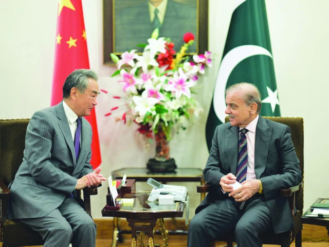 prime minister shehbaz sharif speaks with chinese foreign minister wang yi at the prime minister house in islamabad photo afp