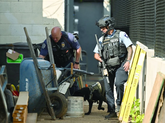 police officers search an alleyway near the scene of a shooting at annunciation catholic school in minneapolis minnesota photo afp police officers search an alleyway near the scene of a shooting at annunciation catholic school in minneapolis minnesota photo afp