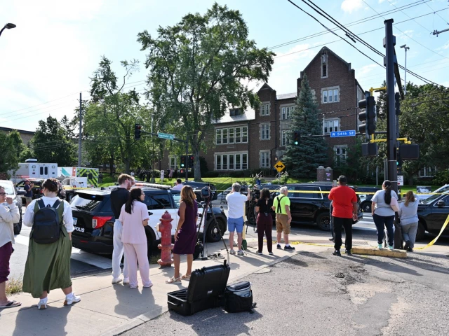 bystanders and media look on near the scene of a shooting at annunciation catholic school in minneapolis minnesota photo afp bystanders and media look on near the scene of a shooting at annunciation catholic school in minneapolis minnesota photo afp