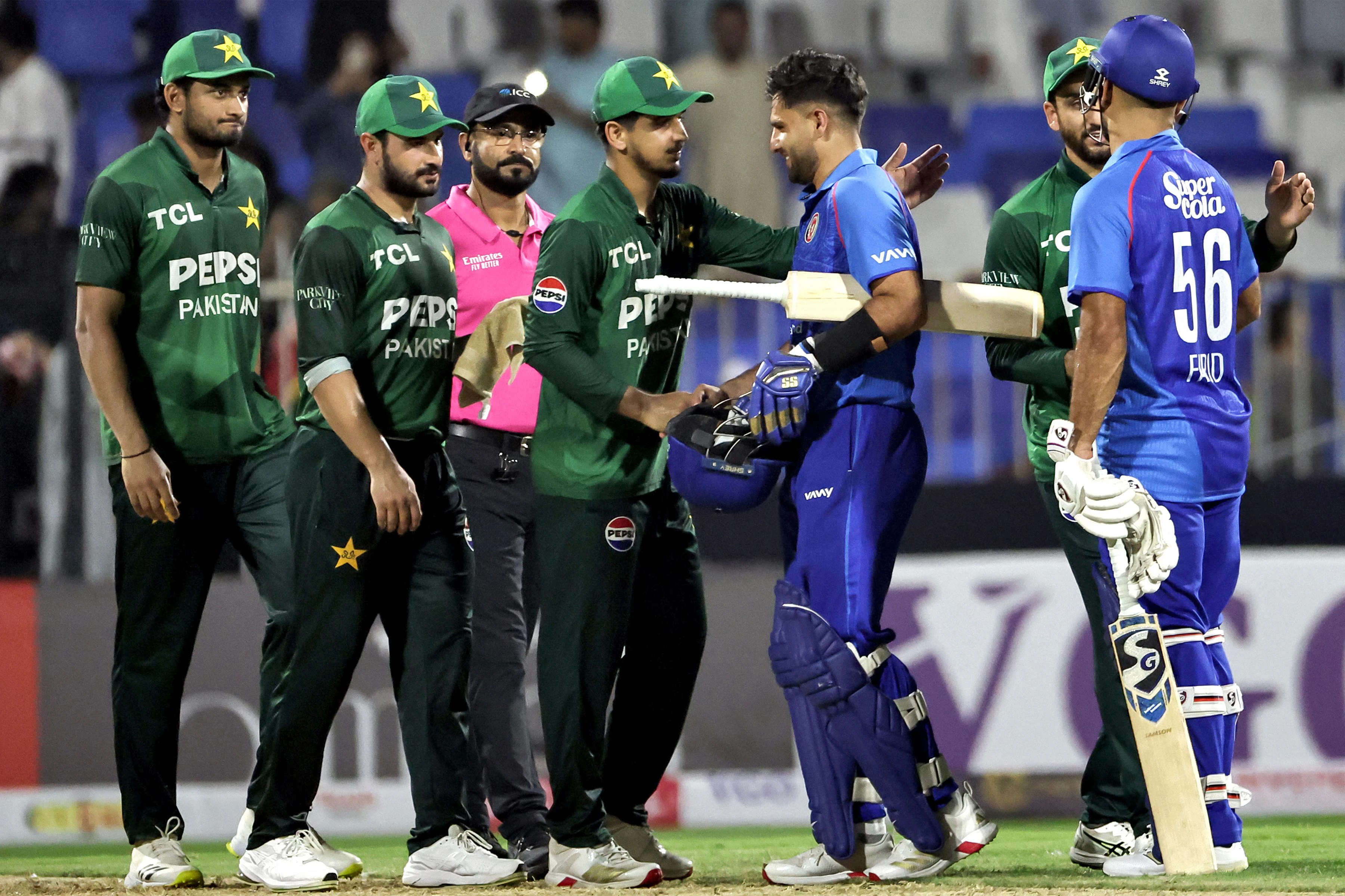 pakistan and afghanistan s players shake hands at the end of their uae tri series match in sharjah photo afp