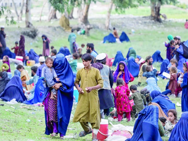 afghan burqa clad women and children take refuge at a ground upon fleeing their homes in the aftermath of an earthquake in kunar province photo afp