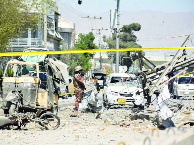 a paramilitary soldier stands amid the debris after a suicide attack near the frontier corps headquarters in quetta photo reuters