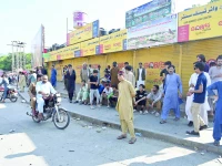 shops in muzaffarabad s bustling market wear a deserted look as traders down shutters during a strike on wednesday photo afp