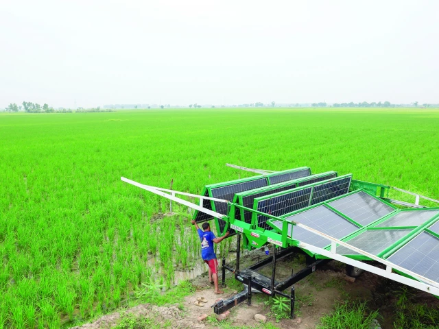 a man unfolds solar panels at his field in muridke photo reuters