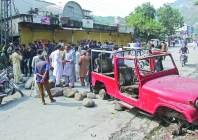 protesters place obstacles on a road during a strike in the ajk capital as government negotiators move to defuse tensions photo reuters