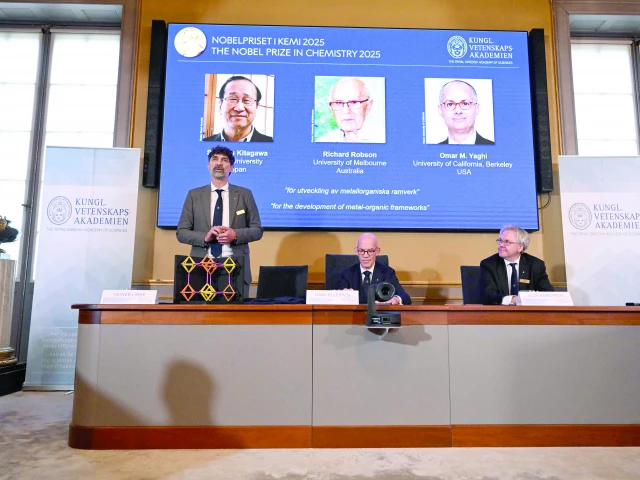heiner linke l chair of the nobel committee for chemistry explains a model as hans ellegren c secretary general of the royal swedish academy of sciences and olof ramstroem member of the nobel committe for chemistry listen during a press conference on the announcement of the winners of the 2025 nobel prize in chemistry at the royal swedish academy of sciences in stockholm photo afp