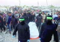 people look on as hamas fighters carry a body retrieved from a tunnel in an area north of khan yunis photo afp