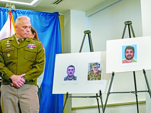 brigadier general leland d blanchard ii looks towards pictures of two national guard members who were shot in washington along with a picture of a suspect afghan national rahmanullah lakanwal at a press conference in washington dc photo reuters