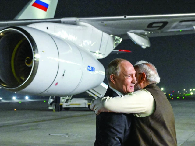 russia s president vladimir putin is welcomed by indian prime minister narendra modi upon his arrival at palam air force base in new delhi photo afp