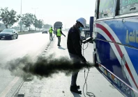 a technician examines a vehicle to test its emissions on a road on the outskirts of islamabad photo afp a technician examines a vehicle to test its emissions on a road on the outskirts of islamabad photo afp