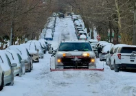 a truck plows snow on a residential street in washongton dc on january 26 2026 photo afp