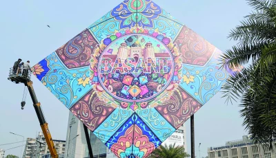 workers install a large kite model to celebrate the basant festival in lahore photo afp