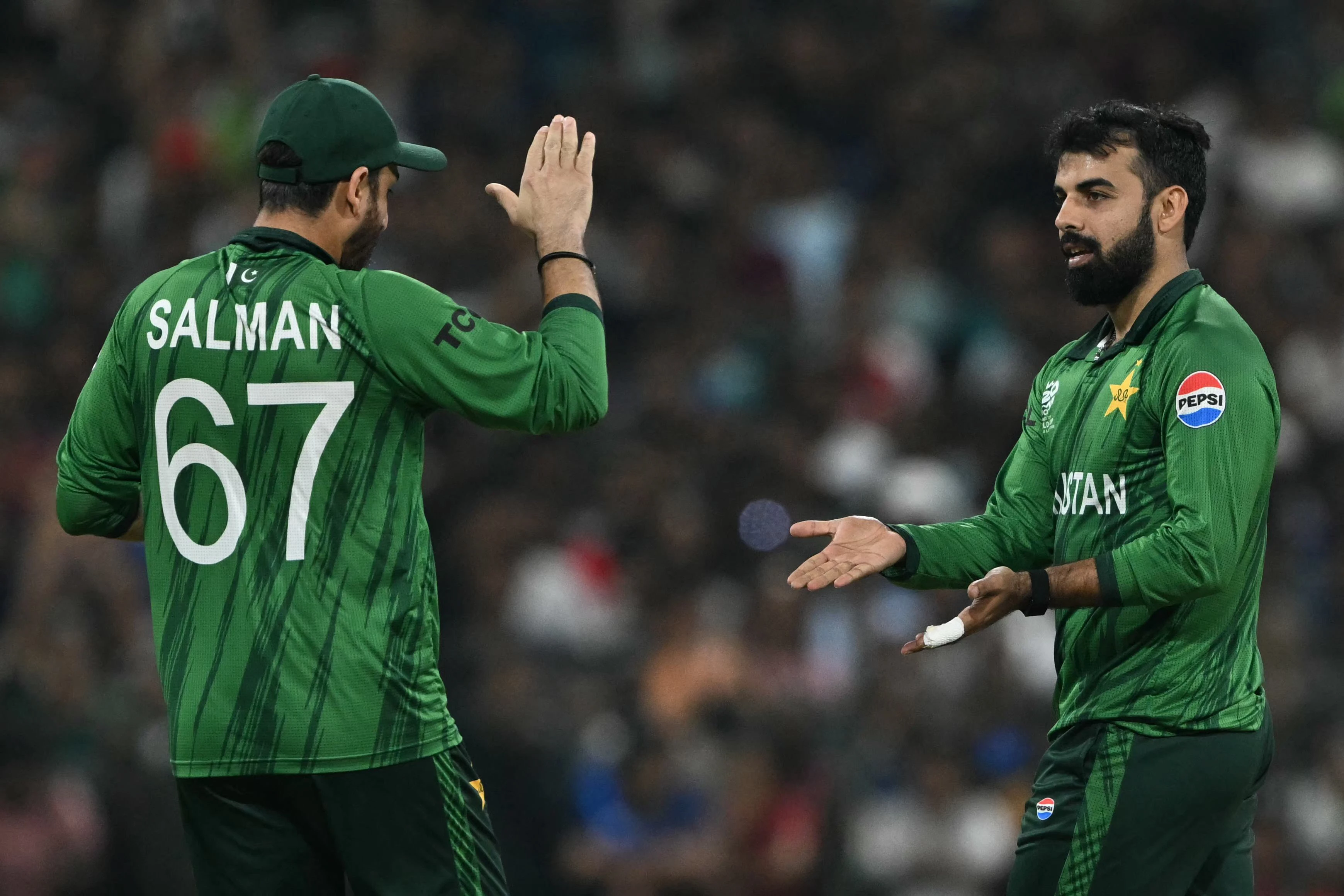 pakistan s shadab khan celebrates with captain salman agha after taking the wicket of usa s shayan jahangir during the 2026 icc men s t20 cricket world cup group stage match between pakistan and usa in colombo on february 10 2026 photo afp