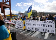 people carry banners at a protest near the united nations office on the day of us mediated peace talks between russia and ukraine in geneva switzerland february 17 2026 photo reuters