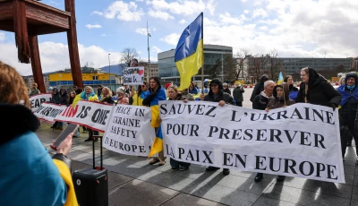 people carry banners at a protest near the united nations office on the day of us mediated peace talks between russia and ukraine in geneva switzerland february 17 2026 photo reuters