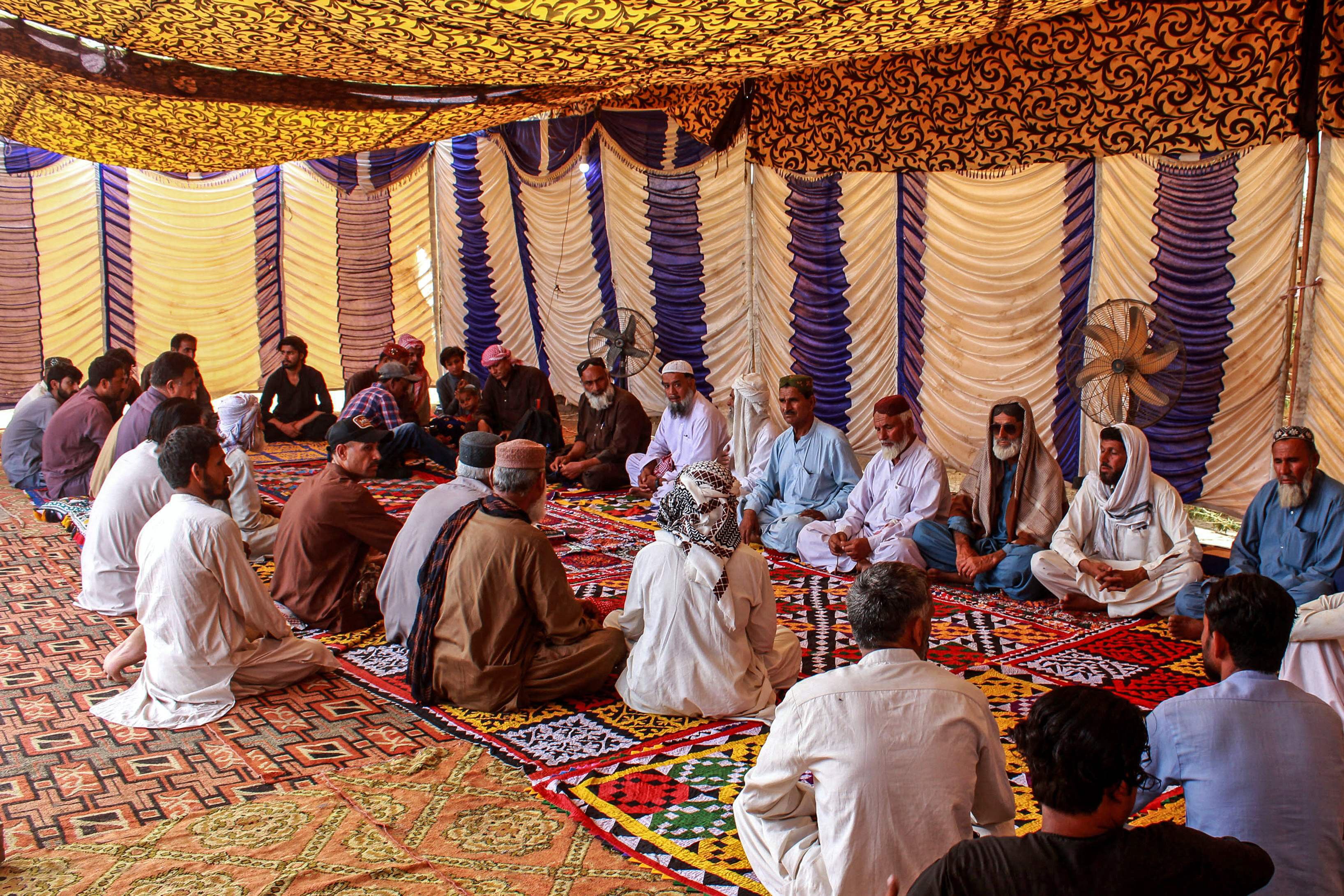 Mourners gather to offer condolences after the death of Pakistani national Muzaffar Ali after his funeral. PHOTO: AFP