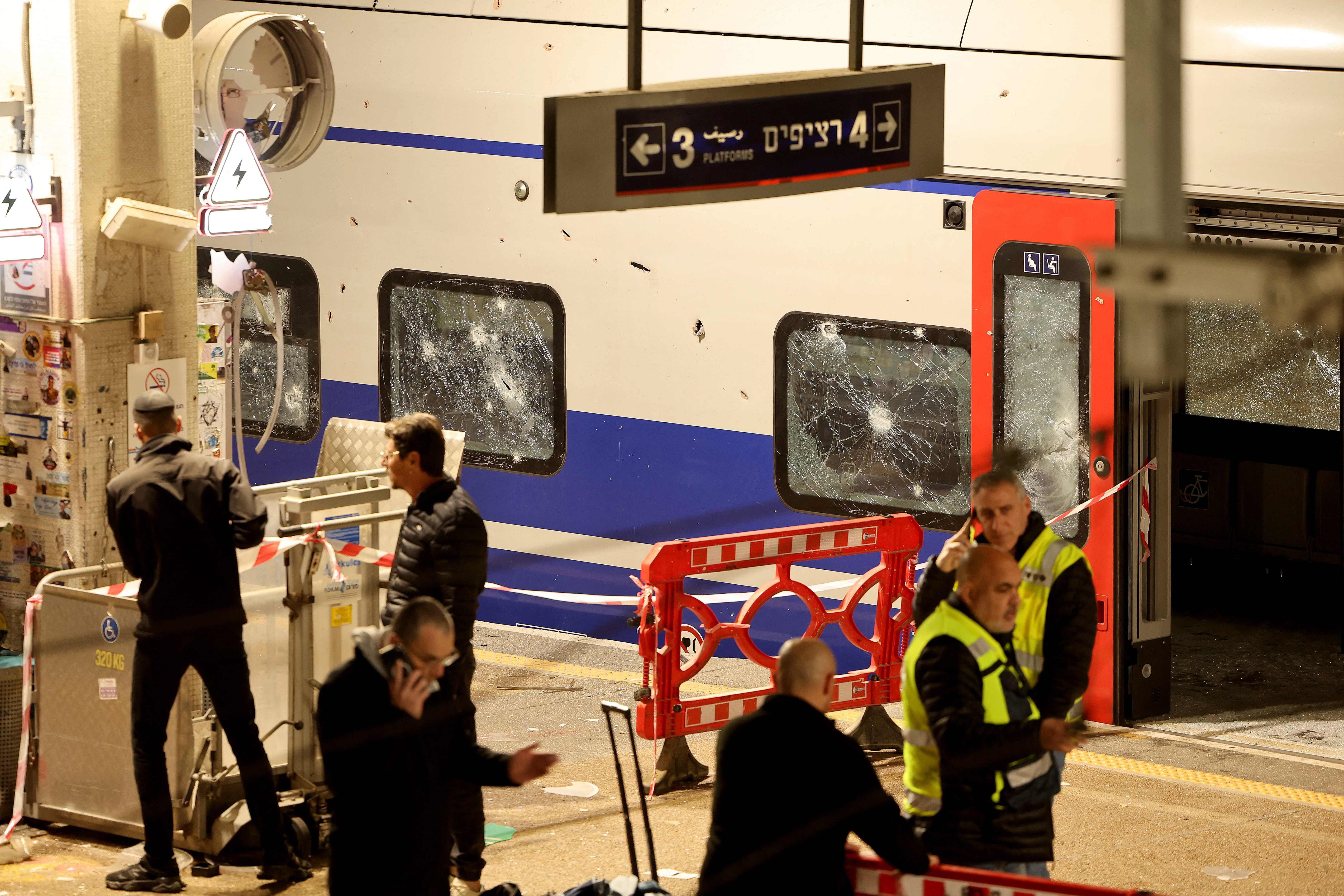 Israeli security forces and rescue workers gather at a train station that was hit by shrapnel after an Iranian strike in Tel Aviv on March 18, 2026. PHOTO: AFP