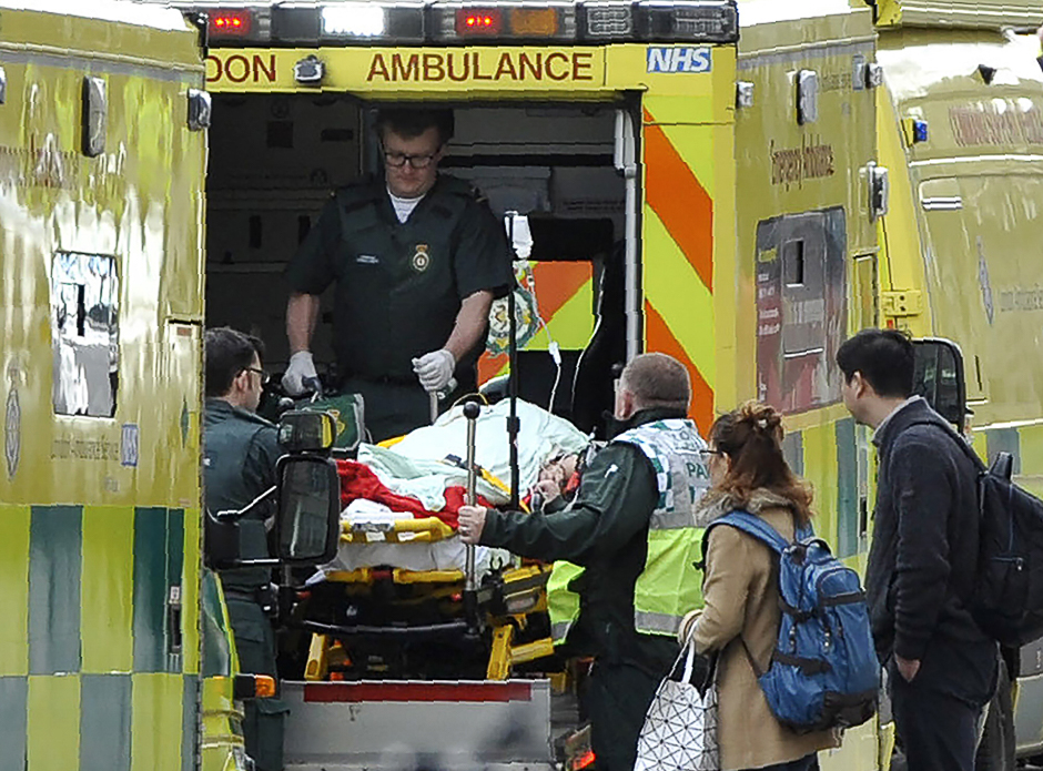 Paramedics load a victim into the back of an ambulance. PHOTO: AFP