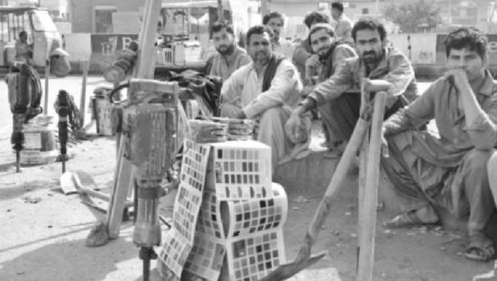 migrant workers wait for clients on a roadside in karachi changing social economic conditions have increased the number of skilled and unskilled labourers coming to urban centres from villages in search of employment photo express