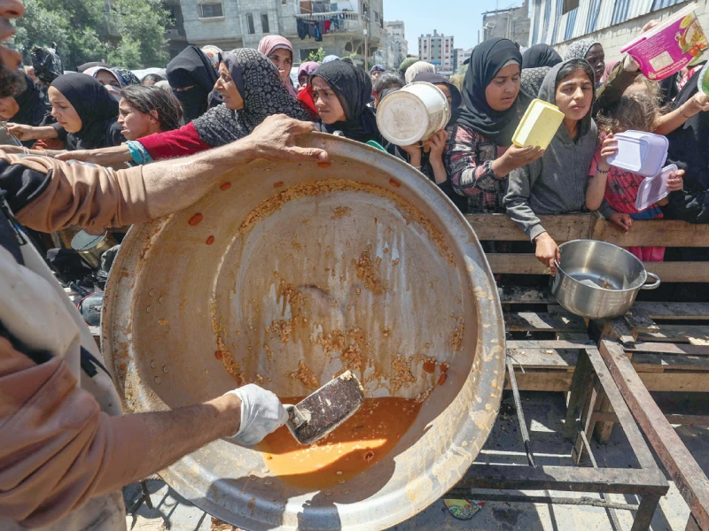 palestinians queue for a portion of hot food distributed by a charity kitchen in gaza photo afp palestinians queue for a portion of hot food distributed by a charity kitchen in gaza photo afp
