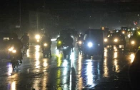 traffic moves slowly along korangi road during light rain as headlights and taillights reflect on the wet asphalt creating a shimmering nighttime scene of cars and motorbikes navigating the slick streets photo jalal qureshi express
