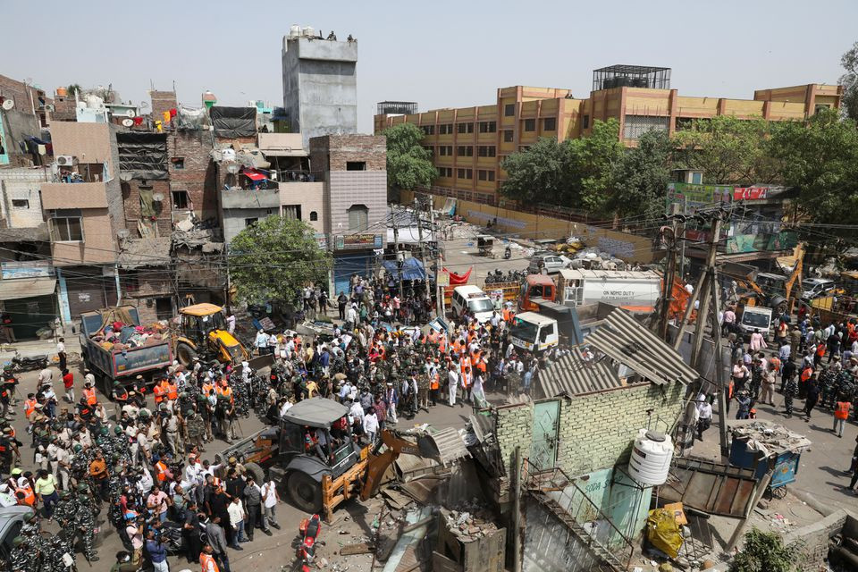 police officials and members of security forces oversee the demolition of small illegal retail shops by civic authorities in a communally sensitive area in jahangirpuri in new delhi india april 20 2022 reuters