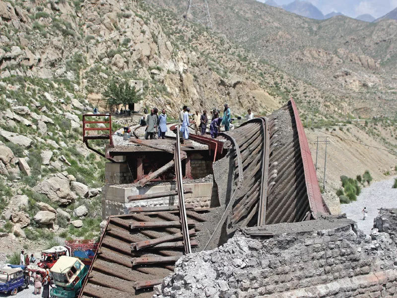 workers stand on damaged railway tracks in bolan photo reuters workers stand on damaged railway tracks in bolan photo reuters