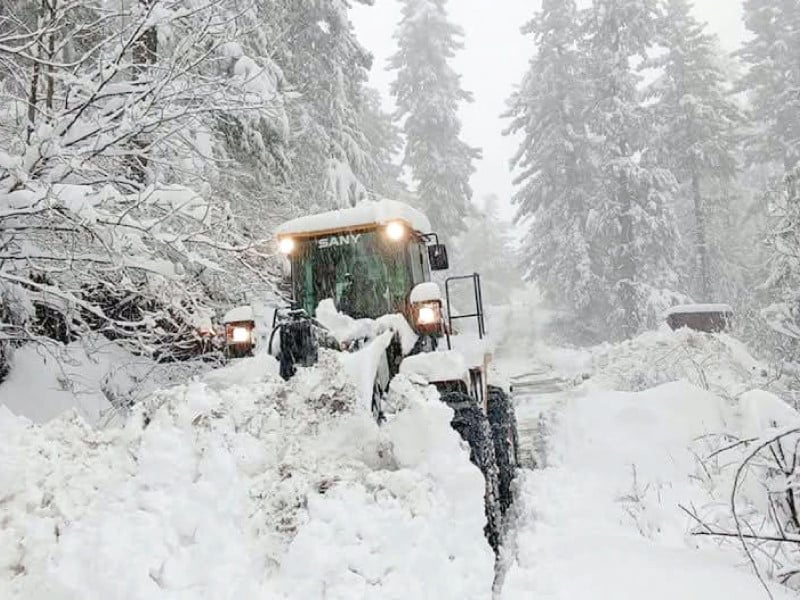 a snow removal machine clears two feet of snow from the shogran road making the route passable and safe once again photo express