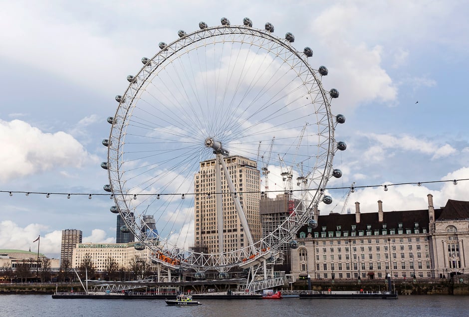 A Police boat passes the London Eye as it patrols along the River Thames, near to the Houses of Parliament in Westminster, central London. PHOTO: AFP