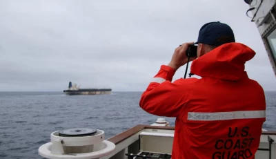 a u s coast guard official looks through binoculars at the ship marinera ex bella 1 in this handout image released january 7 2026 us european command via x handout via reuters a u s coast guard official looks through binoculars at the ship marinera ex bella 1 in this handout image released january 7 2026 us european command via x handout via reuters