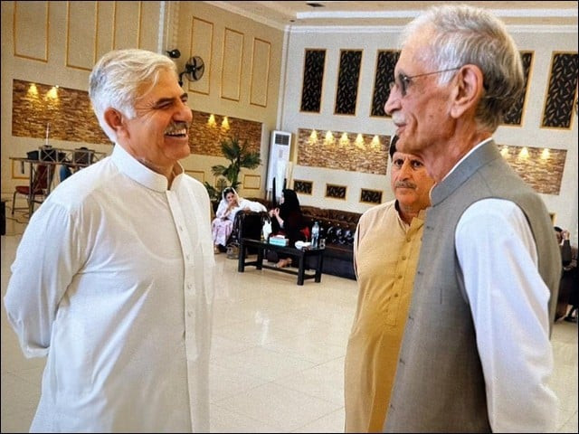 former khyber pakhtunkhwa chief minister pervez khattak r during a firendly exchang with former chief minister mehmood khan l photo file express