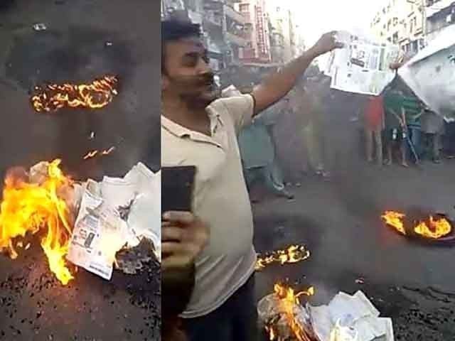 enraged protestors torching their monthly electricity bills during a demonstration screengrab