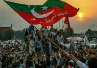 a pakistan tehreek e insaf pti supporter waves the party flag at a rally photo file