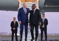 us president joe biden walks on the red carpet next to foreign affairs minister tete antonio upon his arrival in angola photo afp