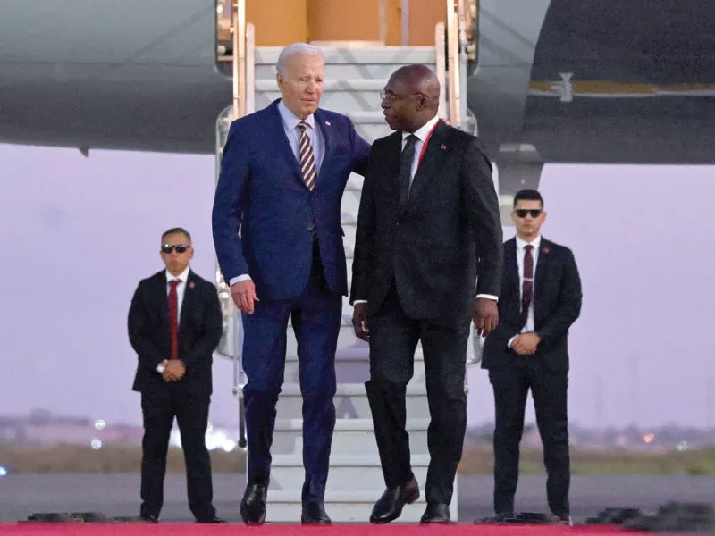 us president joe biden walks on the red carpet next to foreign affairs minister tete antonio upon his arrival in angola photo afp us president joe biden walks on the red carpet next to foreign affairs minister tete antonio upon his arrival in angola photo afp