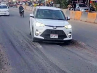 built to break cars take a hazardous ride over the newly opened stretch where uneven surfaces and early signs of sinking have raised safety concerns photo express