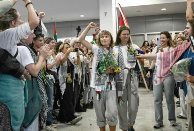 swedish climate campaigner greta thunberg raises her fist at the arrivals area of athens international airport photo afp