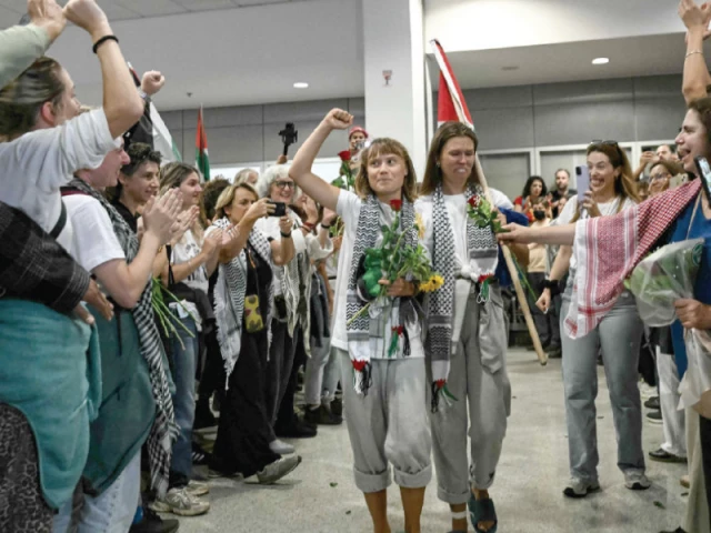 swedish climate campaigner greta thunberg raises her fist at the arrivals area of athens international airport photo afp