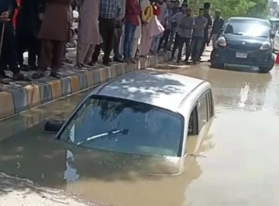 car sinks into road collapse women rescued
