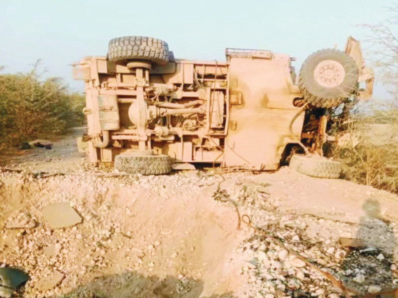 an overturned truck lies along a rural track after an attack on a relief convoy in the bagan area of kurram district on monday photo express