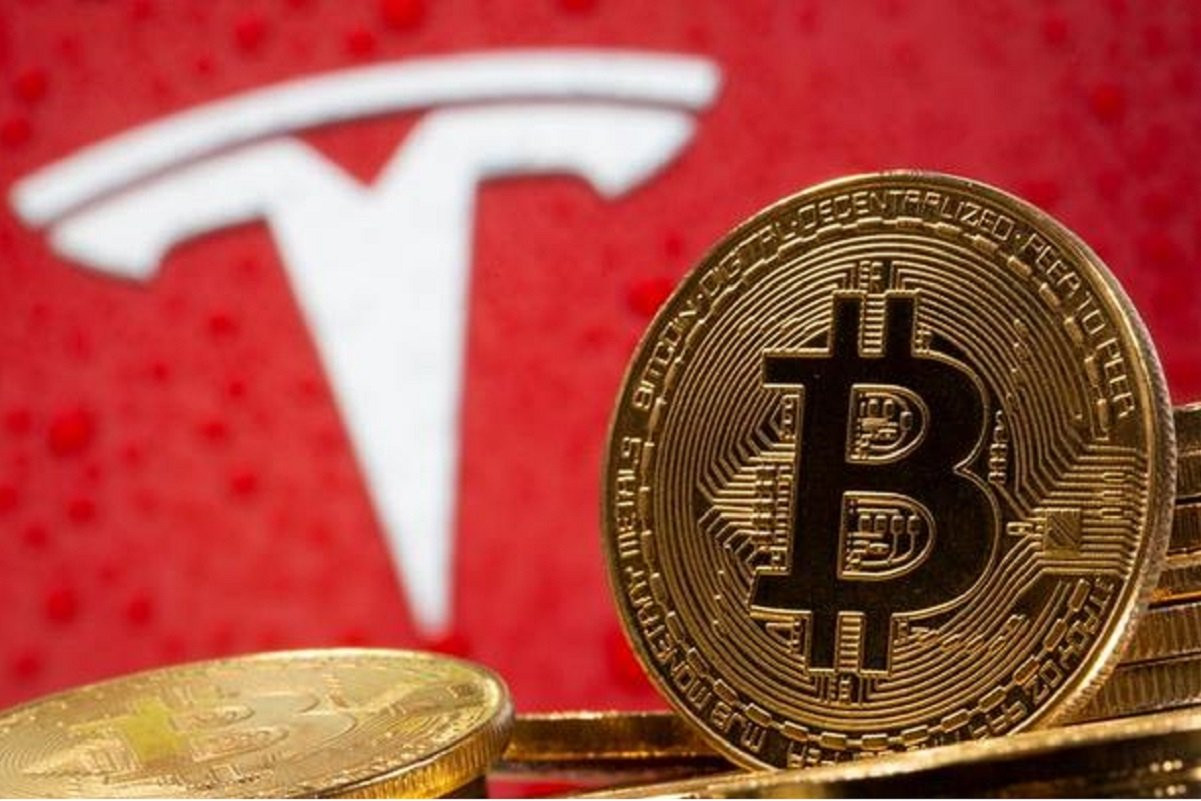 representations of virtual currency bitcoin are seen in front of tesla logo in this illustration taken february 9 2021 photo reuters