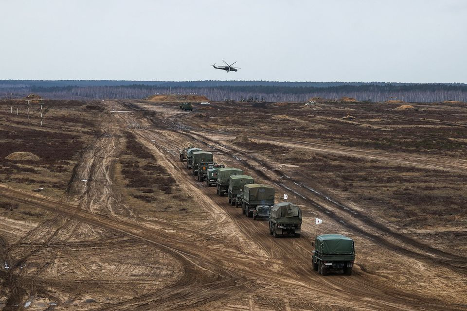 a helicopter flies over troops during the joint military drills of the armed forces of russia and belarus at a firing range in the brest region belarus february 19 2022 vadim yakubyonok belta handout via reuters