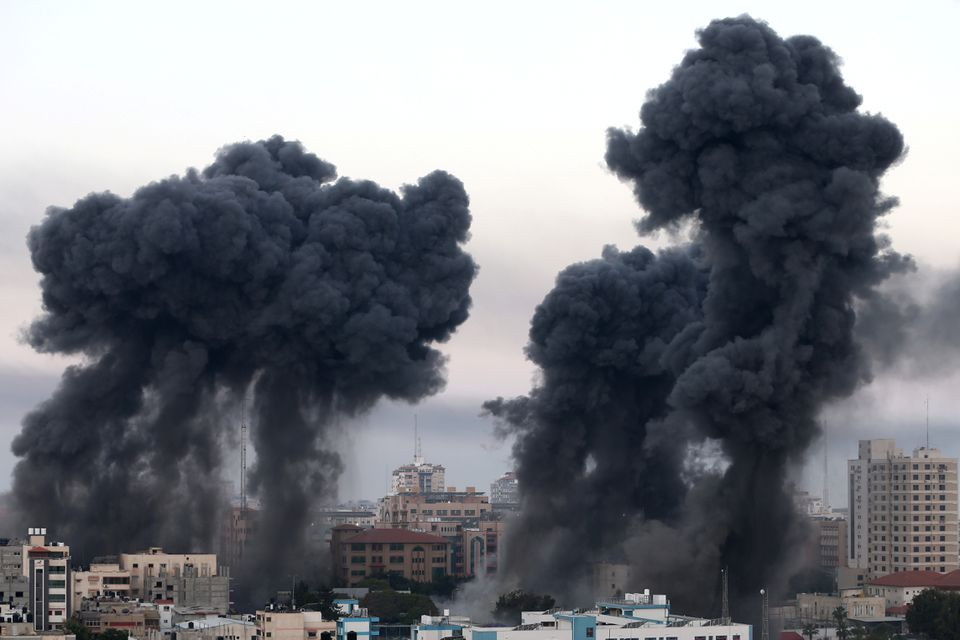 Plumes of smoke rise during Israeli air strikes amid a flare-up of Israeli-Palestinian violence, in Gaza May 12, 2021. PHOTO: REUTERS