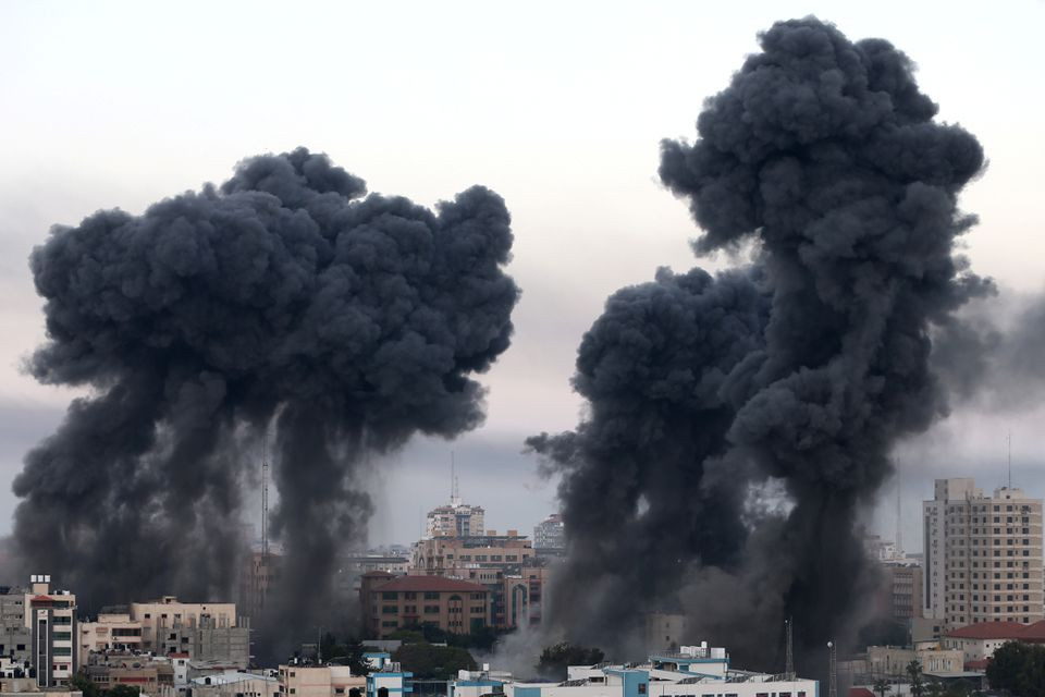 Plumes of fume arise during Israeli atmosphere strikes amid a flare-up of Israeli-Palestinian violence, in Gaza May 12, 2021. PHOTO: REUTERS